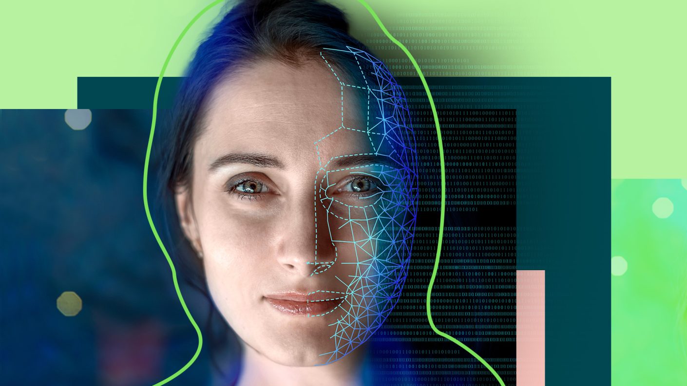 Cropped visual of the face of a female illuminated with the reflection of technological symbols.